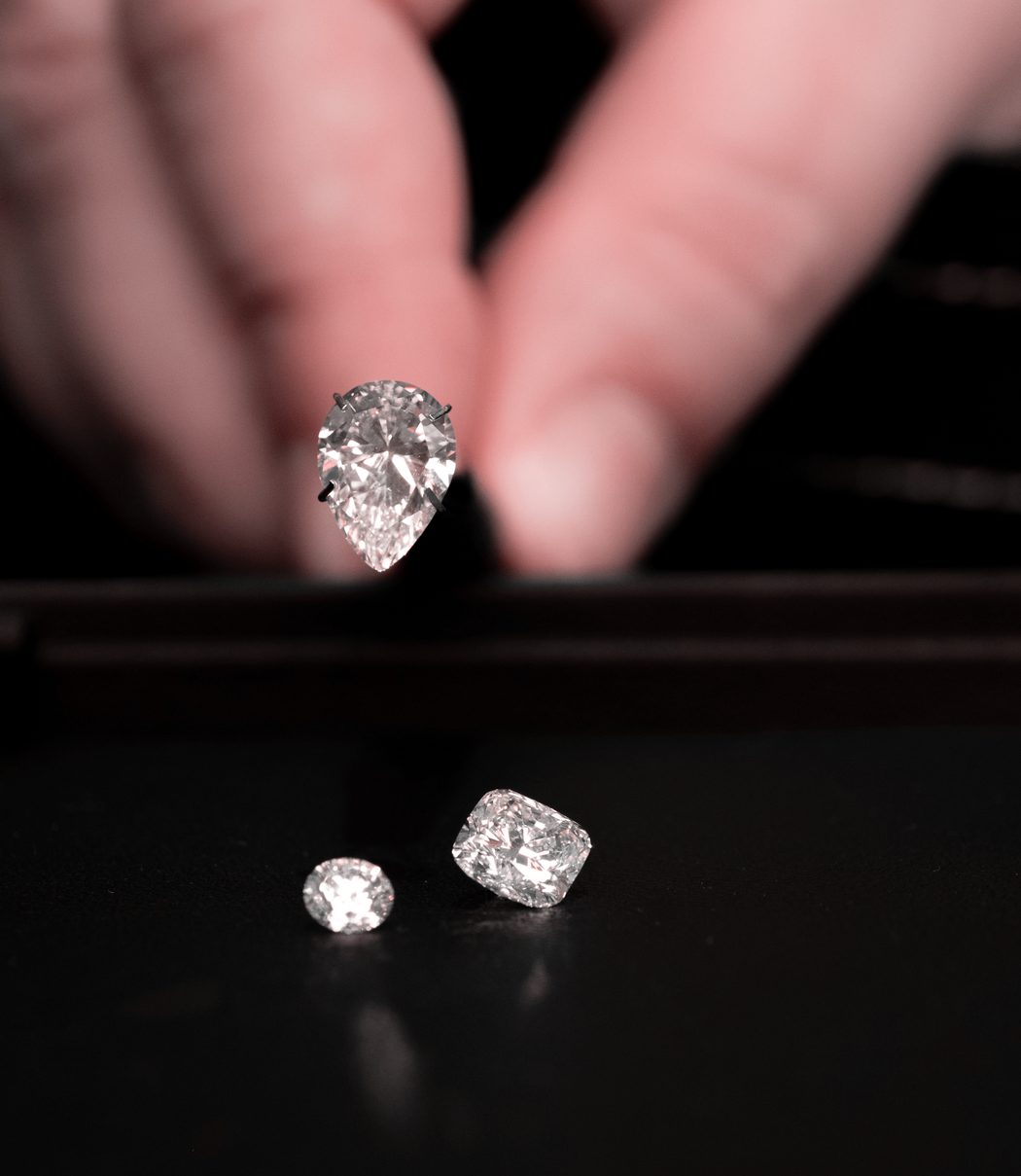 Loose diamonds being examined on a black surface